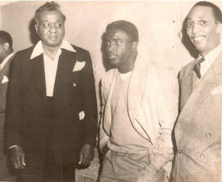 Three men standing in front of wall