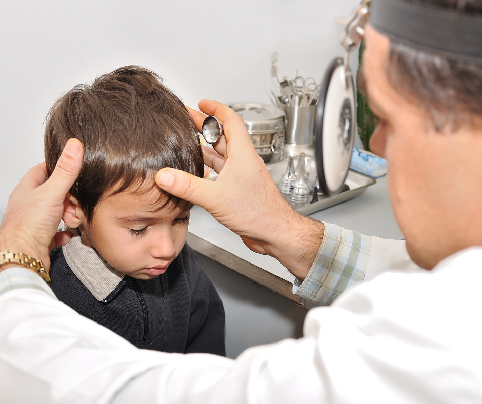 A young child being examined at a doctor's office.