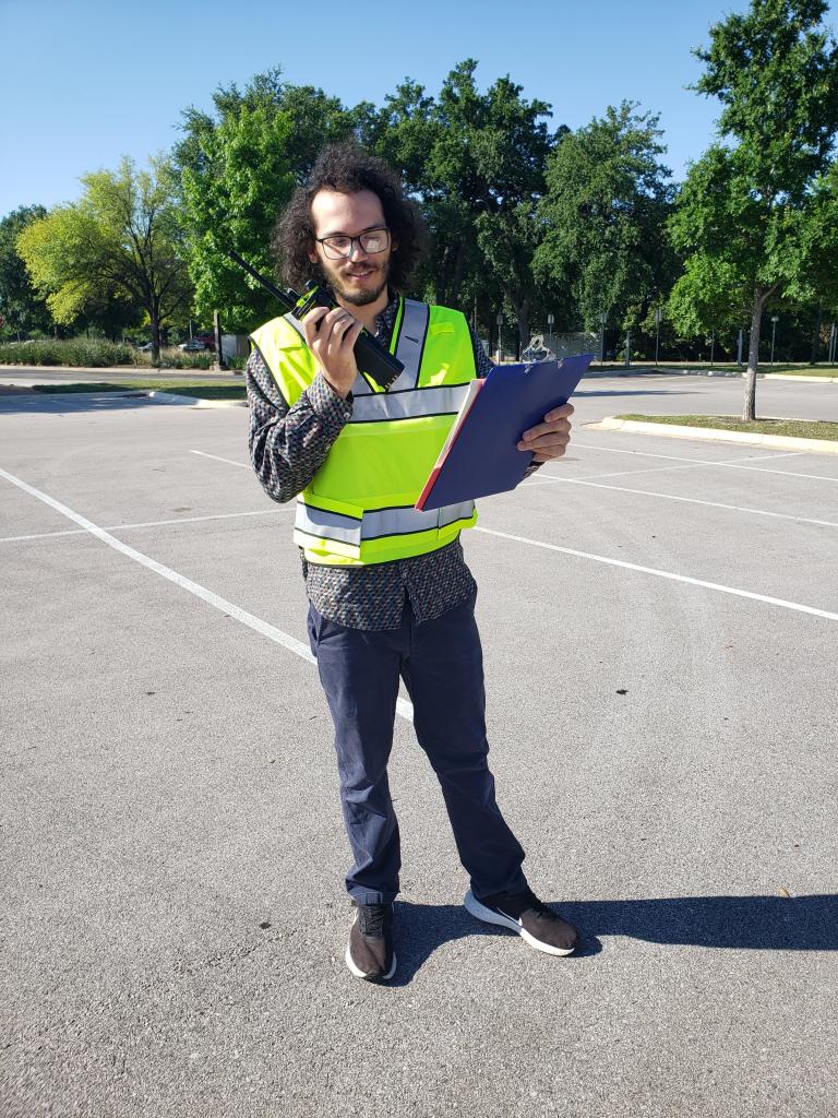 Austin Public Health staff member wearing brightly colored vest used in CASPER survey.