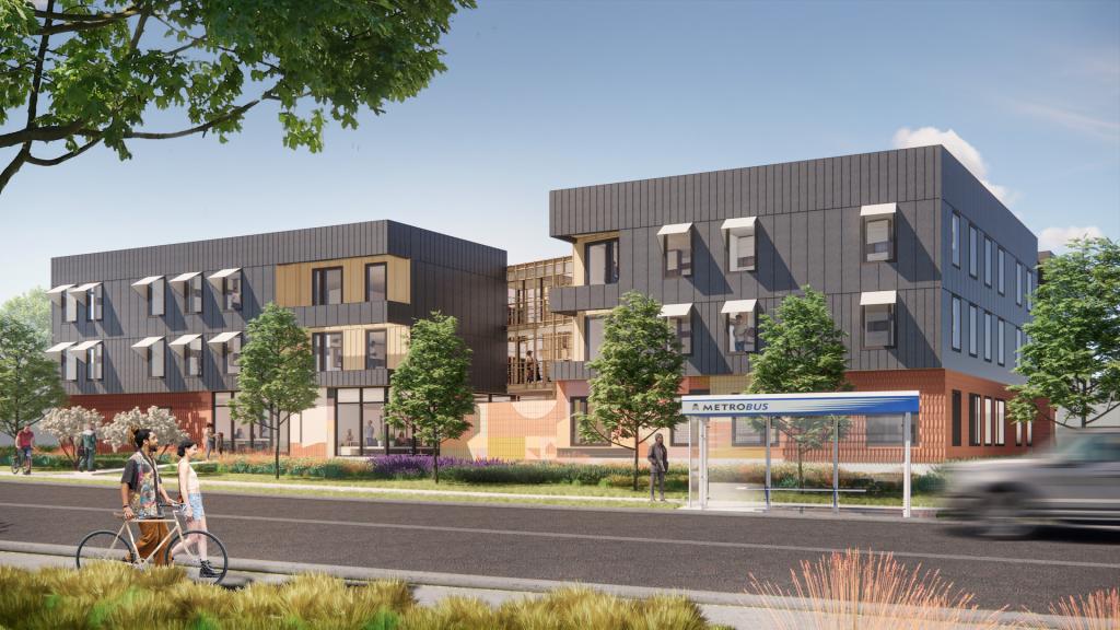 Image shows front facing view of multiple 3-story apartment buildings that make up the Burnet Place Apartments, along with trees and a bus stop. 