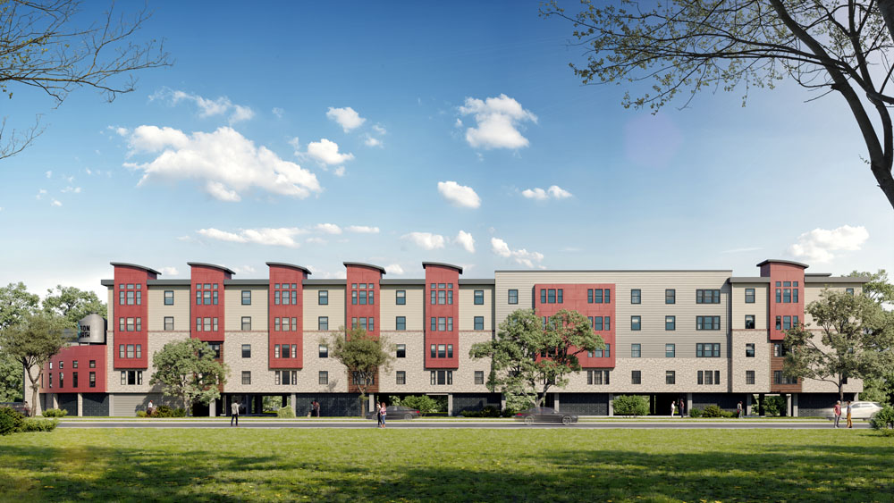 A wide-angle view of a modern, multi-story apartment building named 'Saison North' featuring a mix of red and beige exterior panels with large windows. The building has a contemporary design and is set against a backdrop of a grassy lawn and trees. People can be seen walking and sitting on benches in front of the building, which has a spacious and open setting under a clear blue sky.