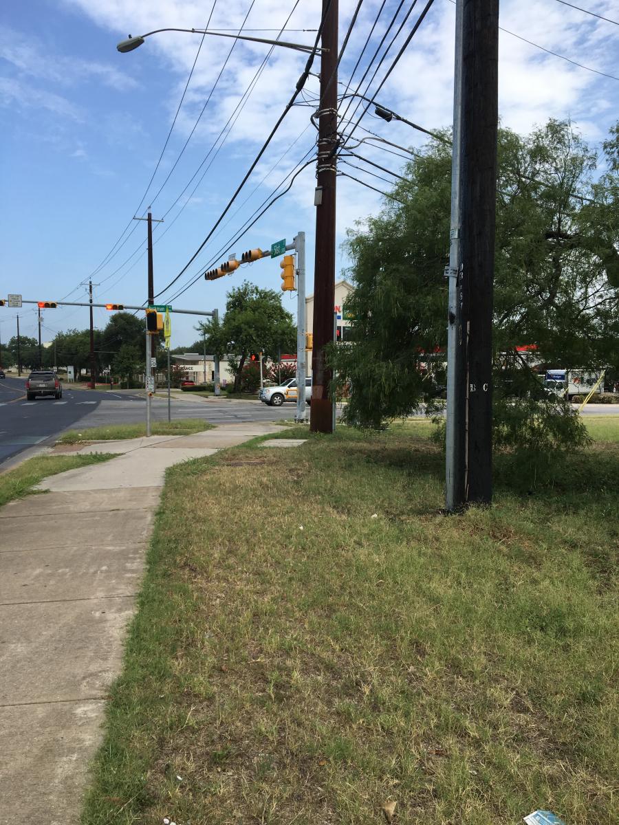 Intersection of E. 51st Street and Berkman Drive at the southwest corner of Bartholomew District Park. Lack of accessible connections and utility conflicts from the street right-of-way into the park.