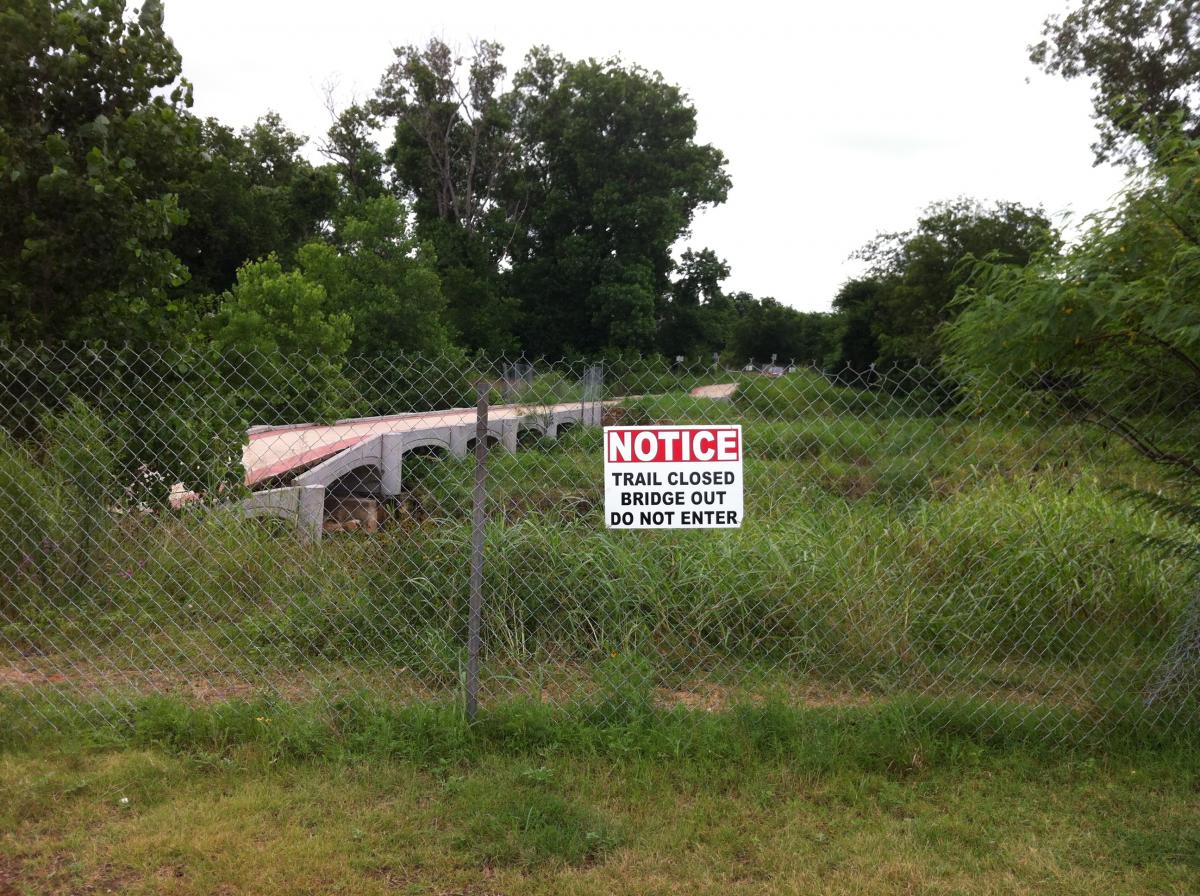 Fence prohibiting entrance to the current state of the bridge.