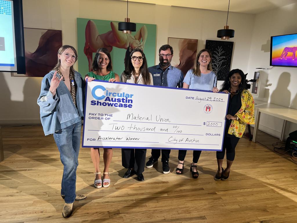 Material Union accepts the $2,000 prize from Maddie Morgan and the judging panel at the 2024 Circular Austin Showcase. 