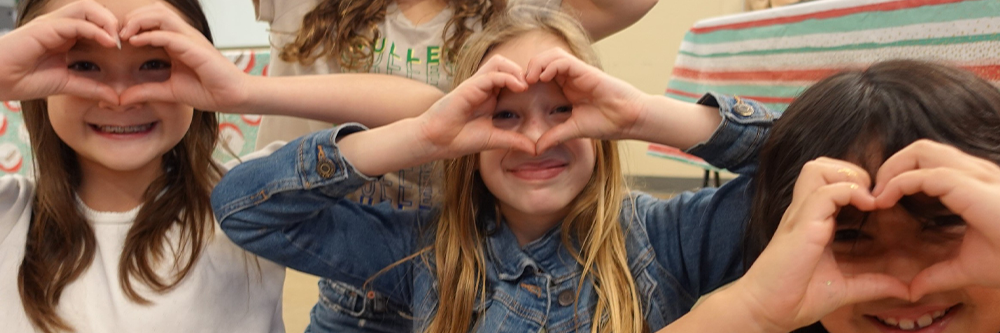 Youth making heart faces