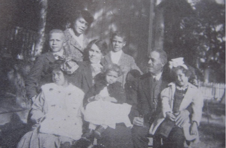 Pictured: President Lovinggood and Family  Back row: Beulah; middle row: Burrows, Roosevelt; Front row: Madeline Alice, Jessalyn, Mattie, Reuben Shannon, Clarissa. Not pictured is Reuben Penman Lovinggood, R. S. Lovinggood’s first son, whose mother, Lilian England, died 19 days after his birth. 