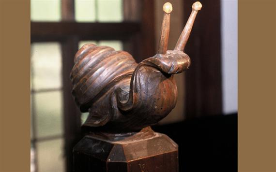 "photo of wooden carved snail"