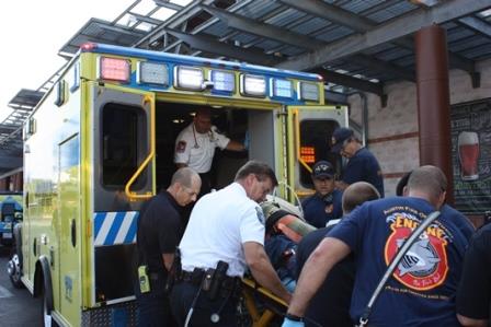 EMS truck and workers loading ambulance