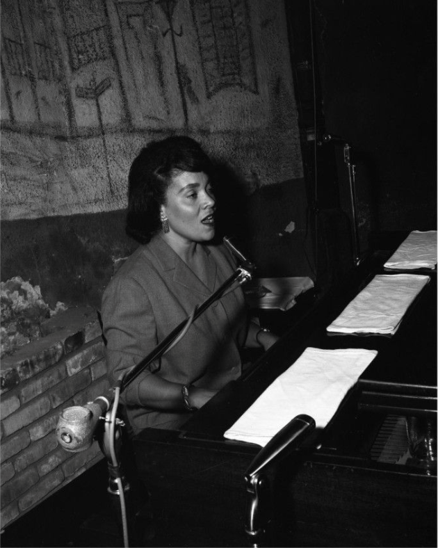 Miller singing and playing piano