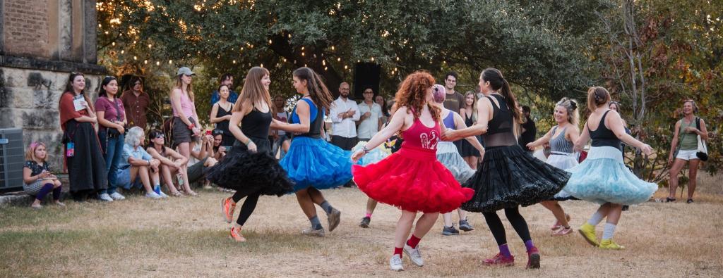 A group of people dancing outside