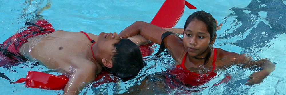Lifeguard rescuing individual in water
