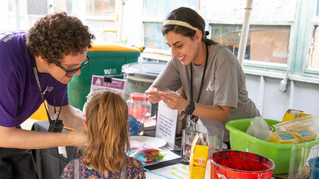 Staff helping kids with art project