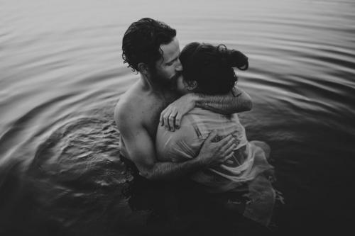 man and woman hugging in water