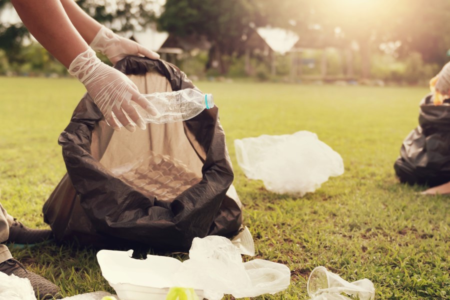 Close up of hands picking up trash