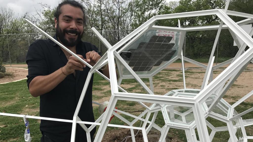 the artists with his sculpture "Exoskeleton" outside the MACC