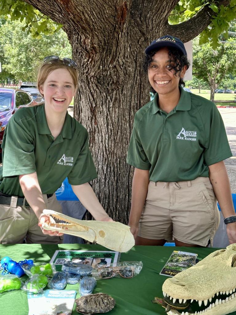 Temporary Rangers smiling behind table with skulls