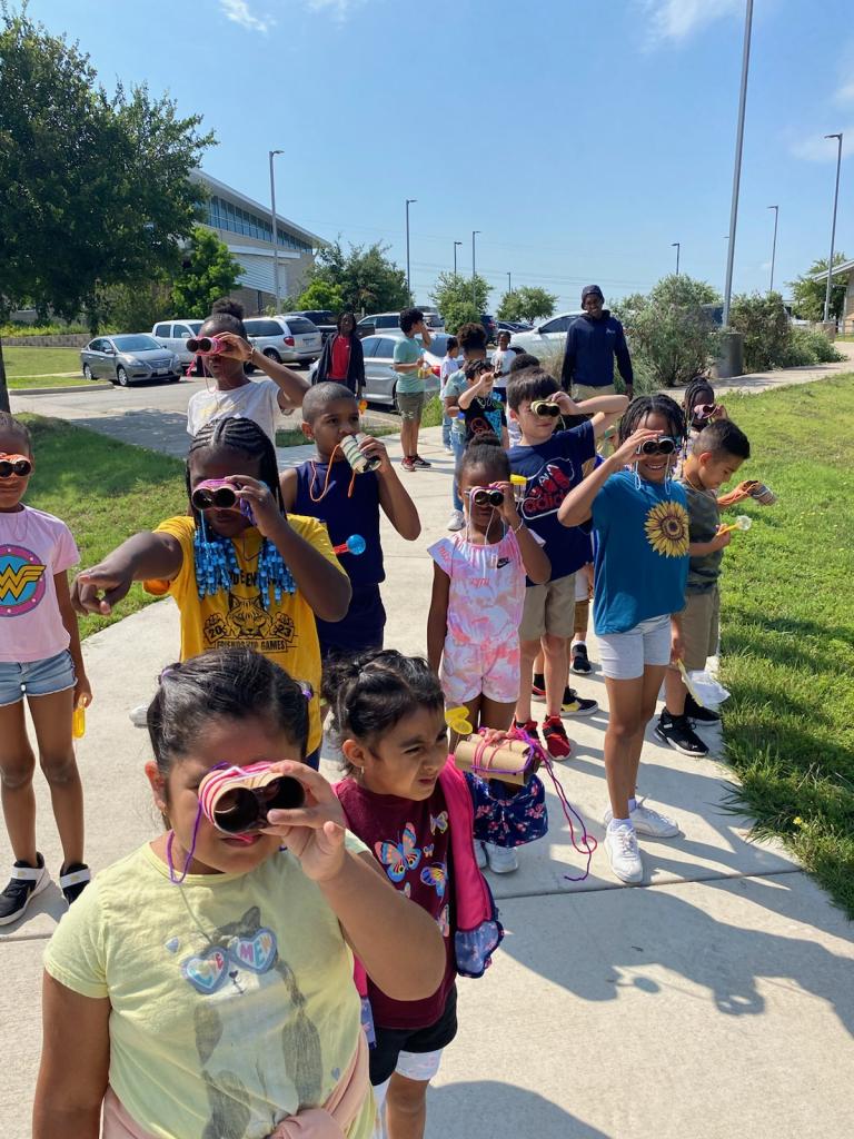 Children exploring with homemade binoculars
