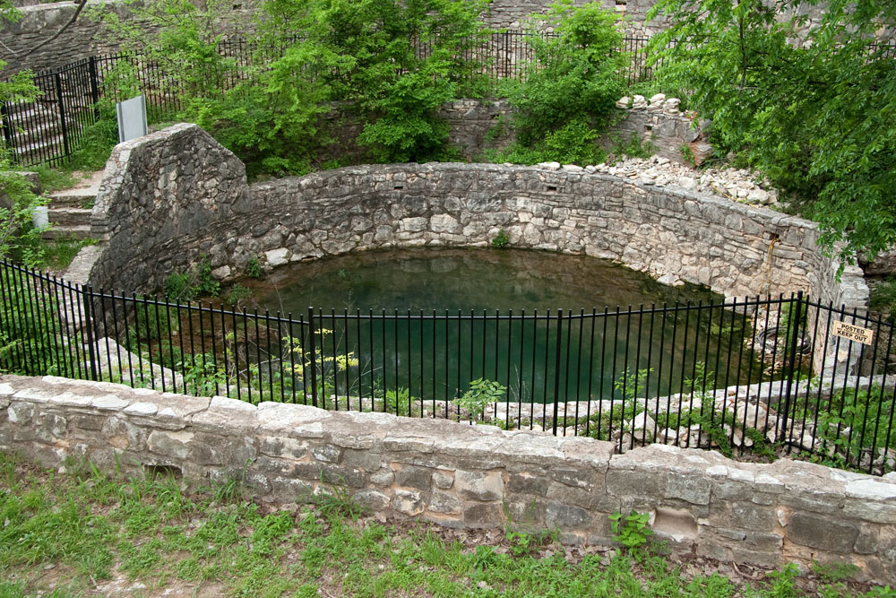 Close up of the center stone wall around the spring-fed pool at Sunken Gardens