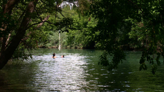 Two people enjoying a swim in the waters of Barton Creek