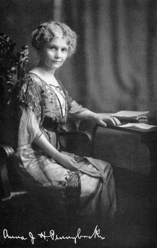 "Photograph of Anna Pennybacker seated at desk, signed by her"