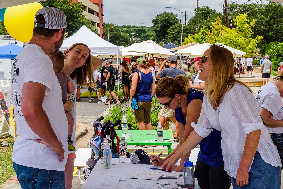 Image of people conversing at a tabling event