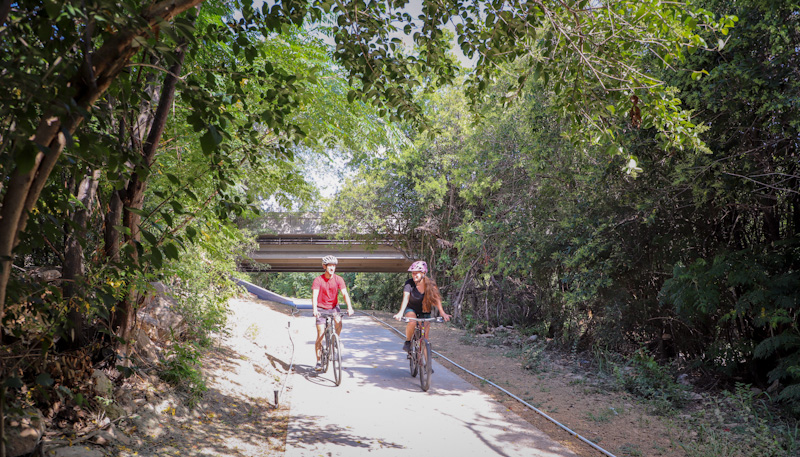 Two people bicycle on the Violet Crown Trail North section