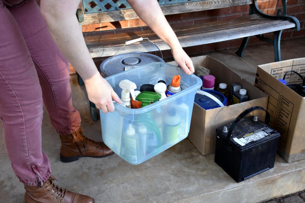 Person loads HHW materials into reusable container.