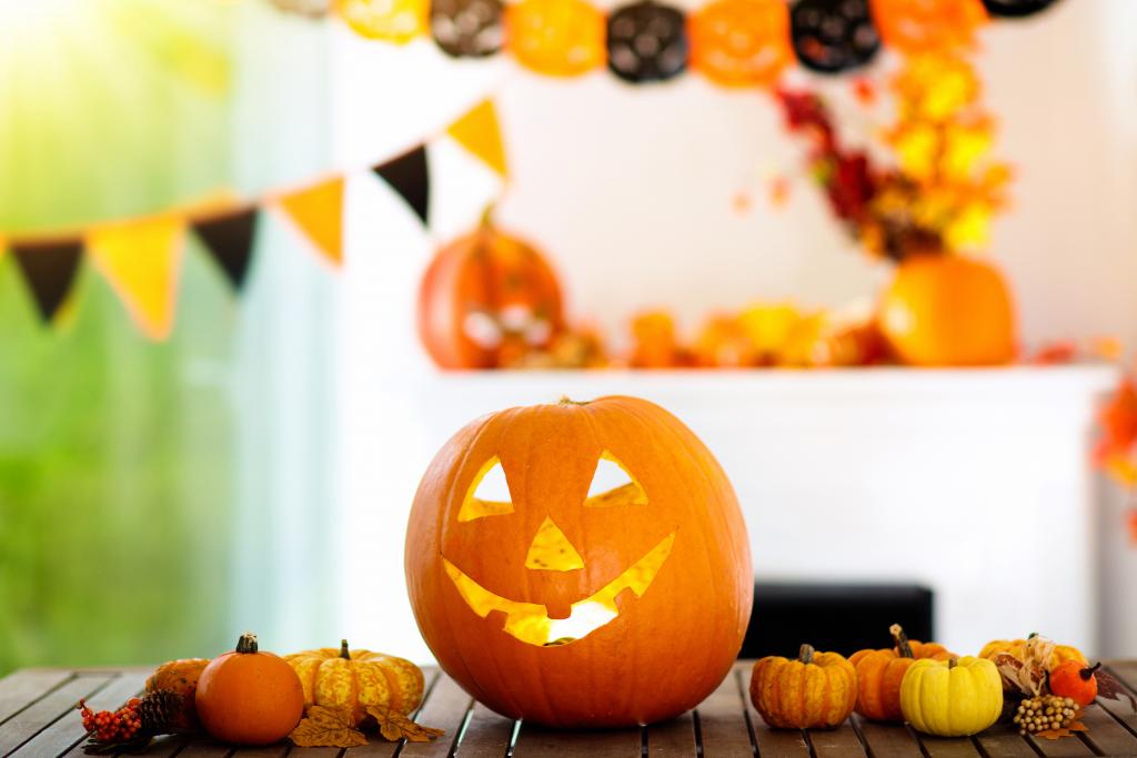 Jack-o-lanterns, gourds and paper orange and black halloween decor