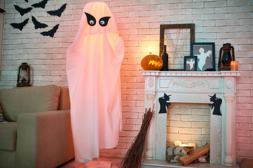 Halloween decor made out of reused items: ghost made out of a bed sheet, paper bats, etc.