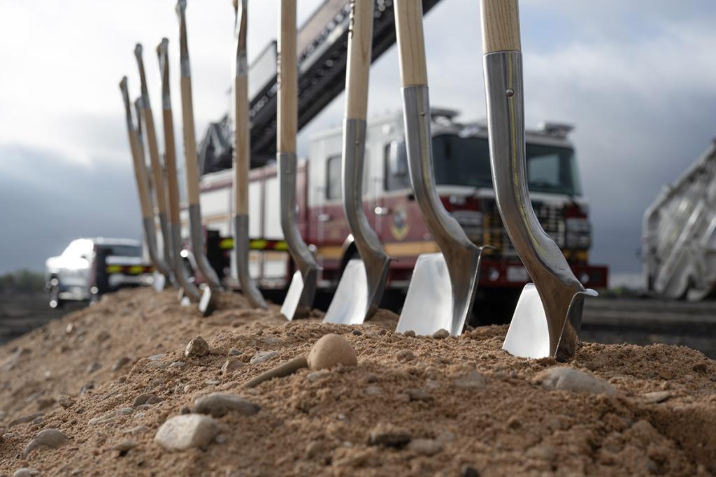 Groundbreaking shovels at the construction site for the Northeast Service Center with a City of Austin fire truck in the background.