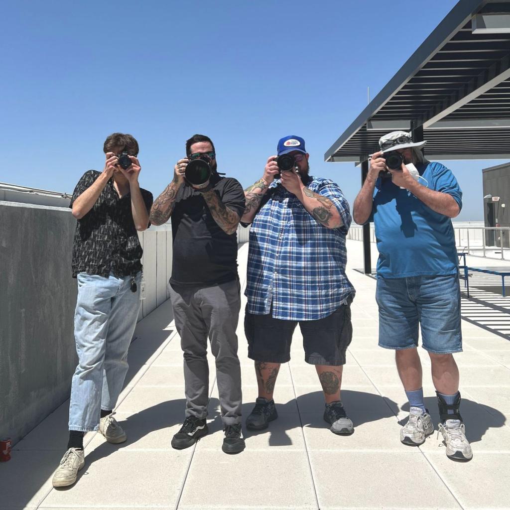 Plane spotters pose with their cameras