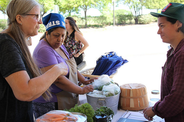 Purchasing food at a farm stand.