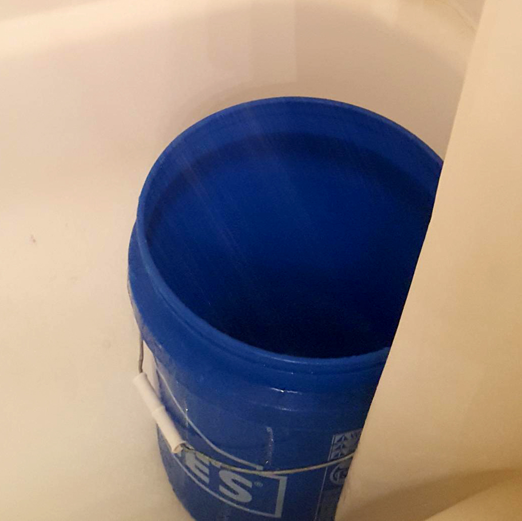 Blue bucket in a shower.