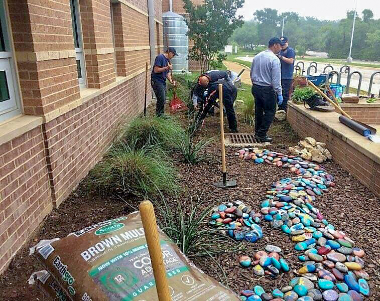 Firefighters working on building a garden.