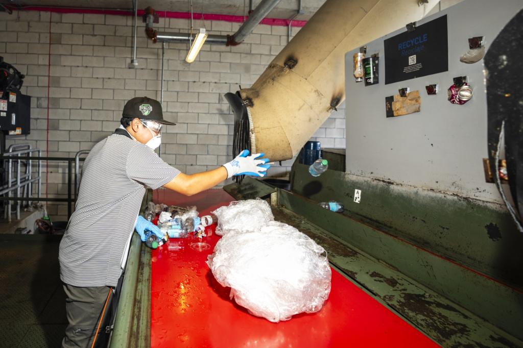 Man sorts the waste in the Mini MRF (Materials Recovery Facility)