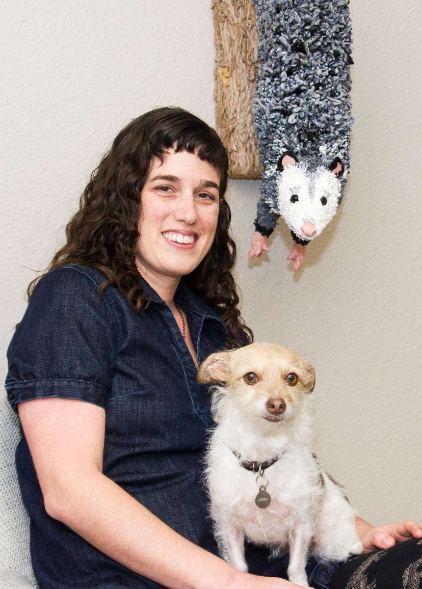 Calder with her dog and artwork.