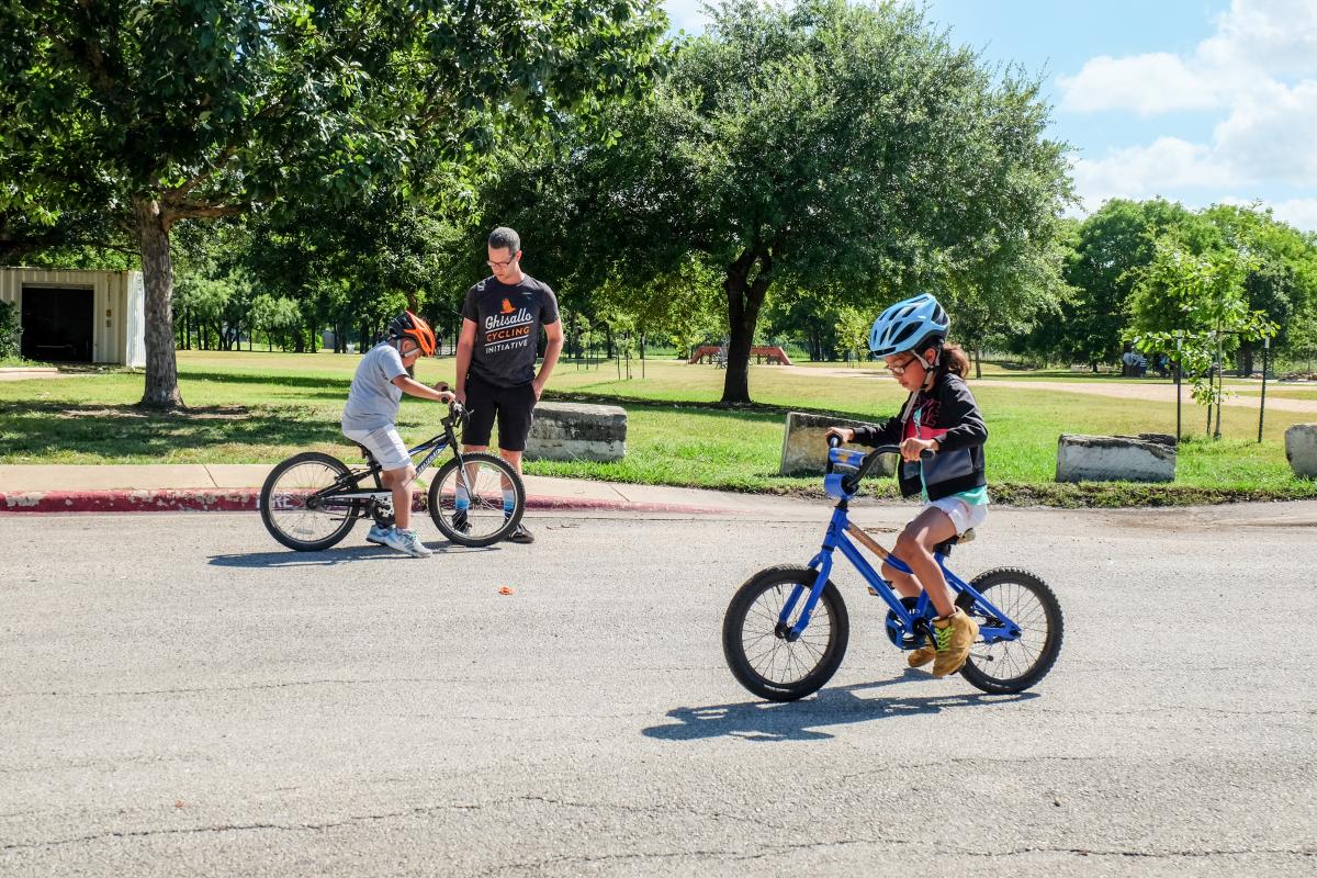 Chris teaching kids to ride balance bikes