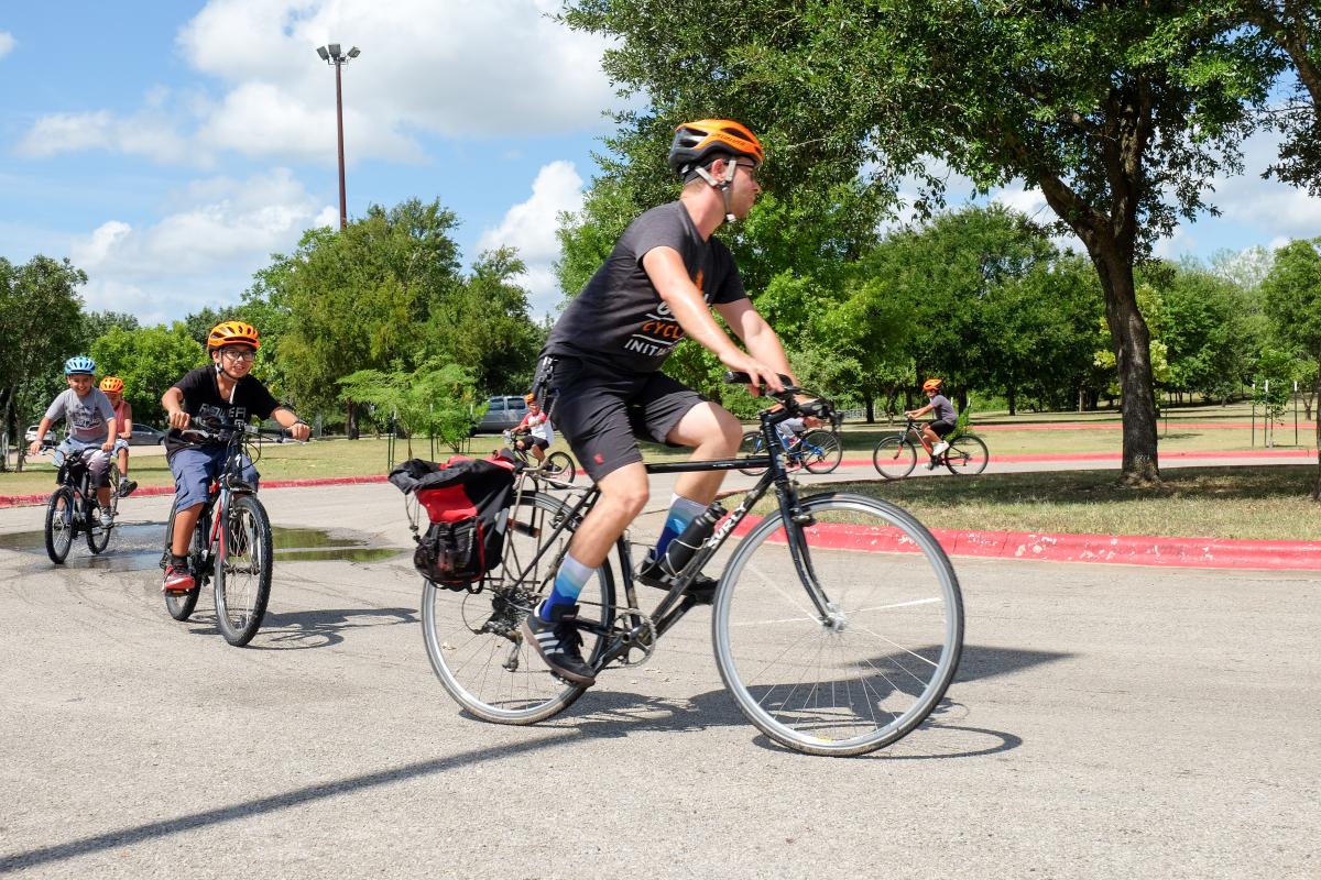 Chris Stanton leads kids around cycle track