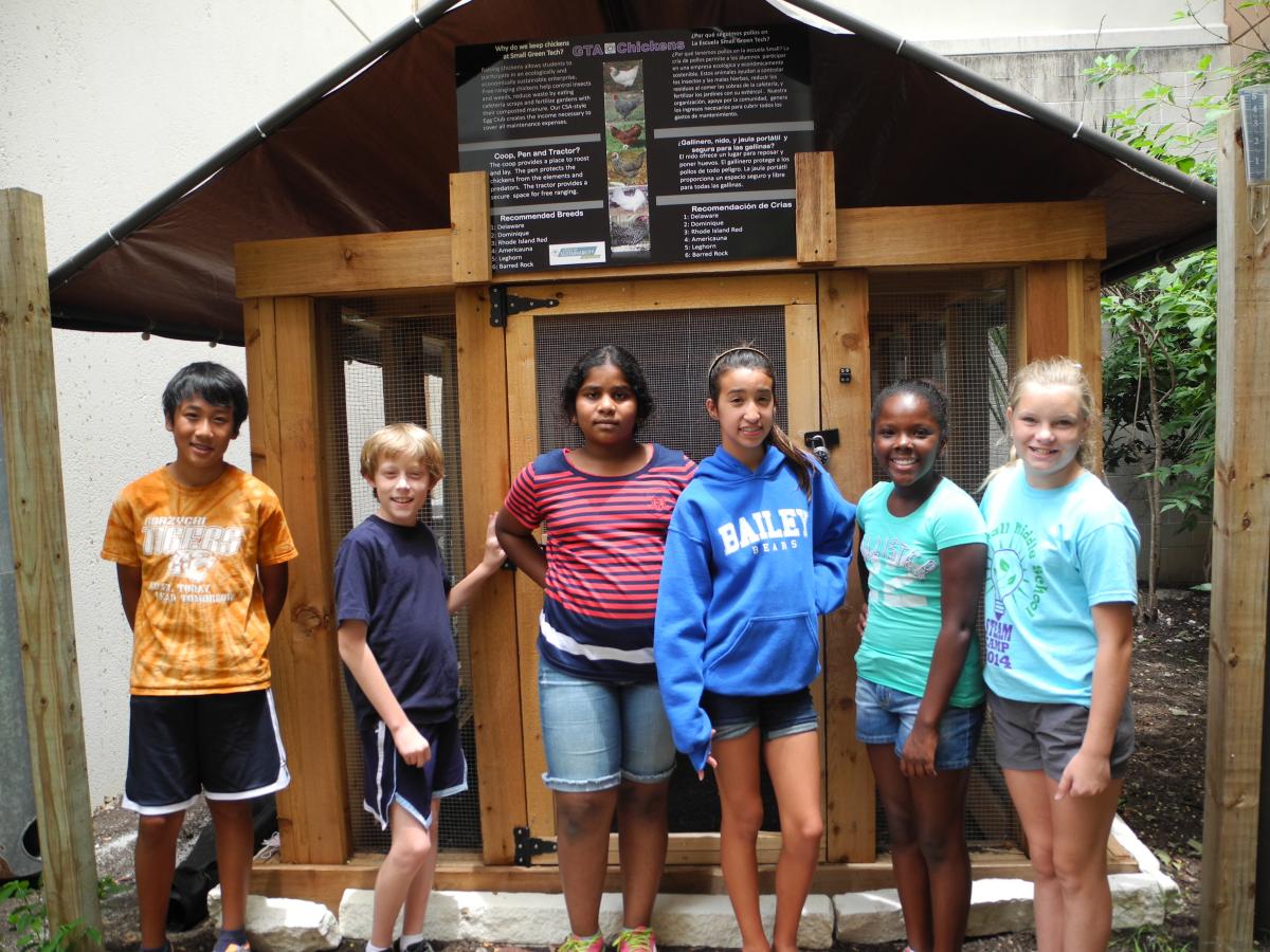 image of students at small middle school by their chicken coop 