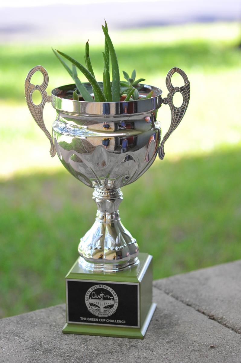 Photo of Green Cup with plants growing in it.