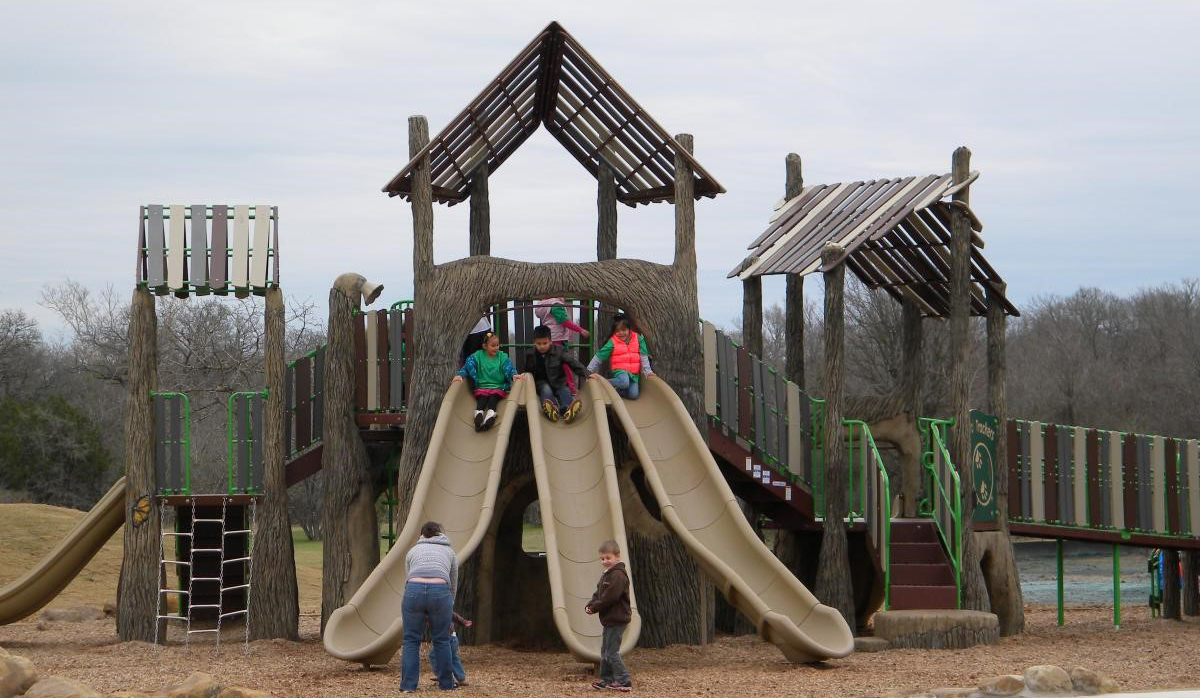 Unique looking playscape with shade and triple slide.