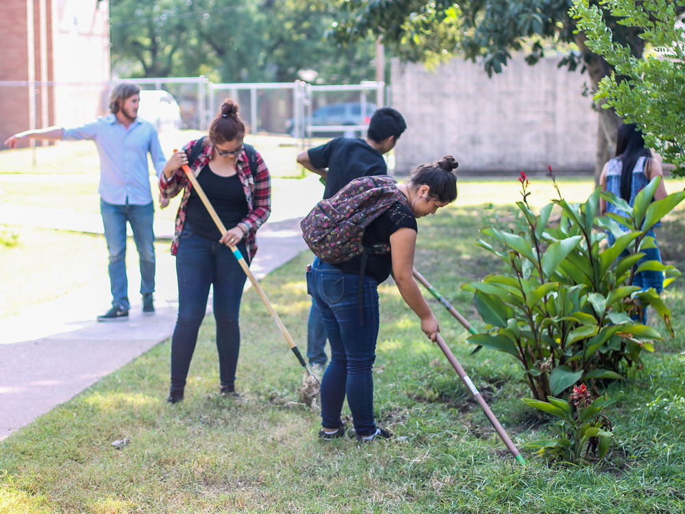 Students working soil on a school campus.