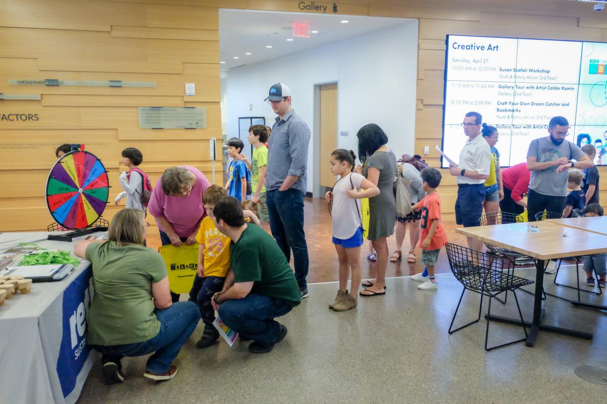 Kids lined up at an outreach table in the Central Library.