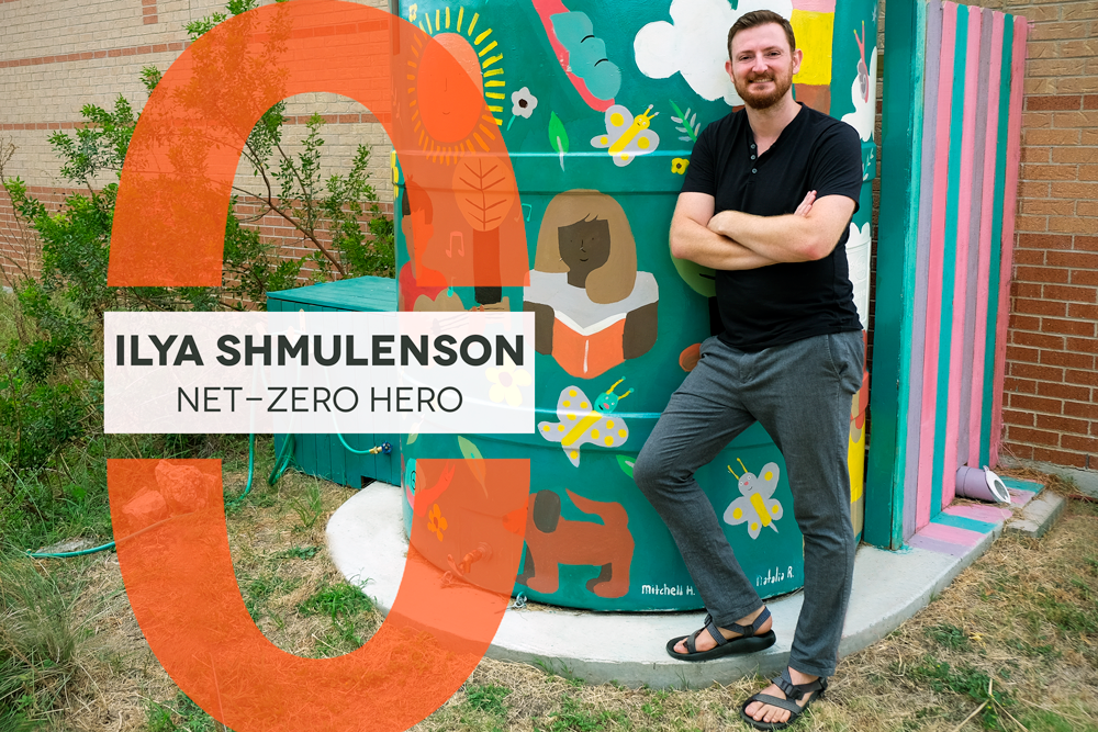 Ilya stands with his arms crossed in front of a colorful painted rainwater tank. Text reads "Ilya Shmulenson Net-Zero Hero"