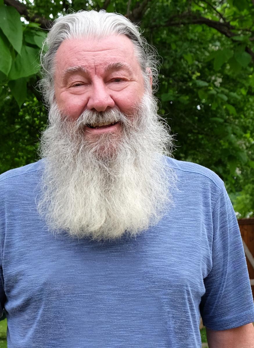 Headshot-style photo of Jerry with a blue shirt on.