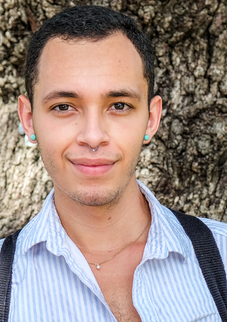 Headshot of Juan with tree bark in the background.