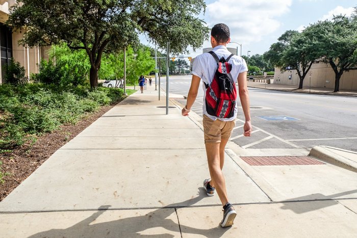 Juan walking down sidewalk