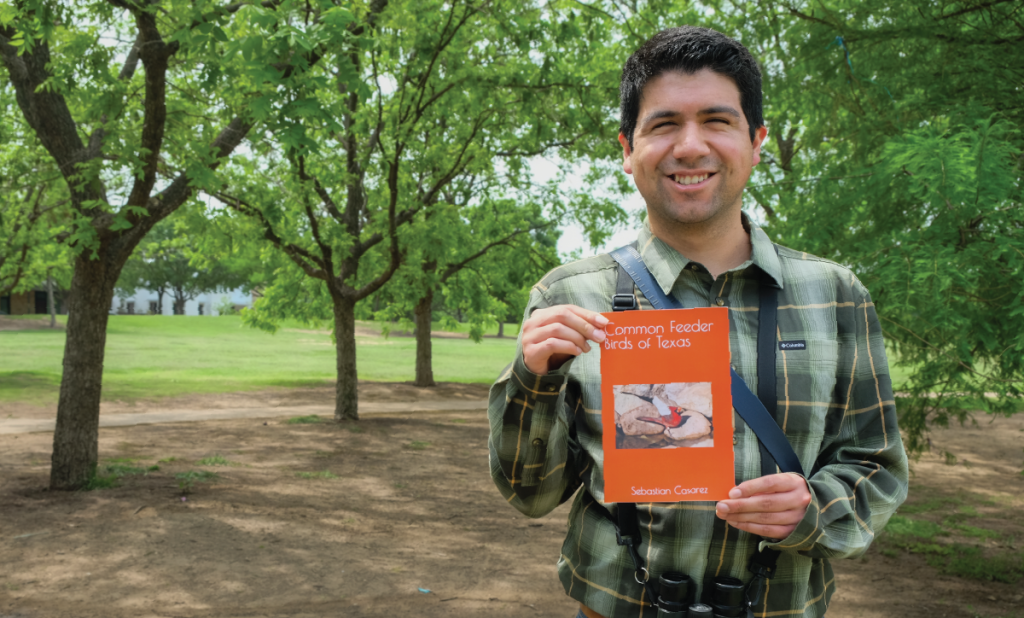 Sebastian holds up a copy of his book, "Common Feeder Birds of Texas."