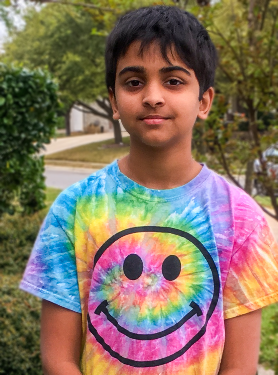 Headshot of Pranav Sarma. He is wearing a tie-dye shirt with a happy face on it.