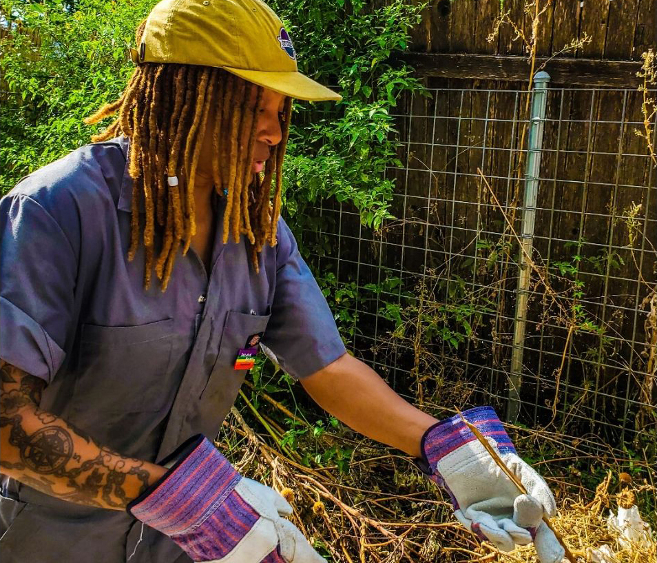 Raasin in work gloves helping with a community clean-up.